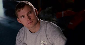 Movie still from “The Guardian” (2006), directed by Andrew Davis – A person wearing a gray t - shirt; Close Up shot, Over the shoulder angle