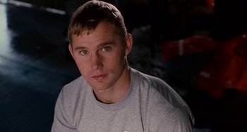 Movie still from “The Guardian” (2006), directed by Andrew Davis – A young man in a gray shirt is looking at the camera; Close Up shot, Over the shoulder angle
