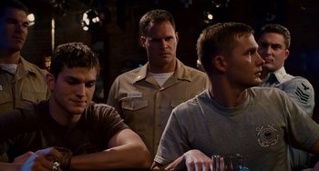 Movie still from “The Guardian” (2006), directed by Andrew Davis – A group of men sitting at a table in a room; Medium shot, Over the shoulder angle