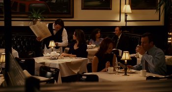 Movie still from “The Guardian” (2006), directed by Andrew Davis – A group of people sitting at a table in a restaurant; Wide shot, Over the shoulder angle