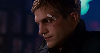 Movie still from “The Guardian” (2006), directed by Andrew Davis – A man with a bandage on his forehead; Close Up shot, Low angle