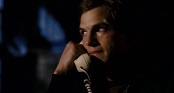 Movie still from “The Guardian” (2006), directed by Andrew Davis – A man holding a phone up to his ear; Close Up shot, Over the shoulder angle