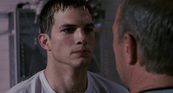 Movie still from “The Guardian” (2006), directed by Andrew Davis – A person wearing a white shirt; Close Up shot, Over the shoulder angle