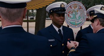 Movie still from “The Guardian” (2006), directed by Andrew Davis – A man in a military uniform standing next to another man; Medium shot, Over the shoulder angle