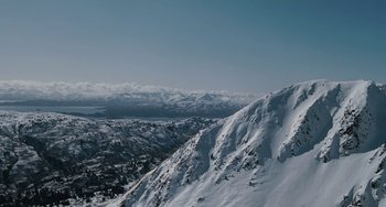 Movie still from “The Guardian” (2006), directed by Andrew Davis – A view of a snowy mountain with a view of a valley; Extreme Wide shot, Low angle
