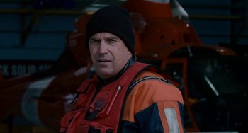 Movie still from “The Guardian” (2006), directed by Andrew Davis – A man wearing a life jacket and a hat; Close Up shot, Over the shoulder angle