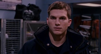 Movie still from “The Guardian” (2006), directed by Andrew Davis – A man in a black jacket is looking at the camera; Close Up shot, Over the shoulder angle