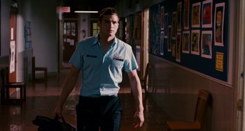 Movie still from “The Guardian” (2006), directed by Andrew Davis – A man walking down a hall way holding a bag; Medium shot, Low angle