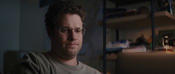 Movie still from “The Guilt Trip” (2012), directed by Anne Fletcher – A person wearing glasses and a gray shirt; Close Up shot, Over the shoulder angle