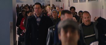 Movie still from “The Guilt Trip” (2012), directed by Anne Fletcher – A group of people standing in a room; Medium shot, Over the shoulder angle