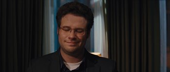 Movie still from “The Guilt Trip” (2012), directed by Anne Fletcher – A person wearing a suit and glasses; Close Up shot, Over the shoulder angle