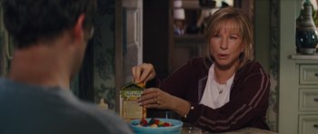 Movie still from “The Guilt Trip” (2012), directed by Anne Fletcher – A woman sitting at a table with a bowl of fruit; Close Up shot, High angle