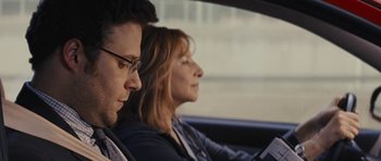 Movie still from “The Guilt Trip” (2012), directed by Anne Fletcher – A man and a woman sitting in the back of a car; Close Up shot, Over the shoulder angle
