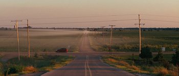 Movie still from “The Guilt Trip” (2012), directed by Anne Fletcher – A car driving down a road near a field; Extreme Wide shot, High angle