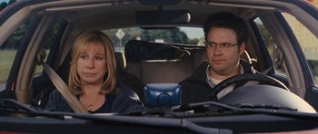 Movie still from “The Guilt Trip” (2012), directed by Anne Fletcher – A man and a woman sitting in the back seat of a car; Medium shot, Over the shoulder angle