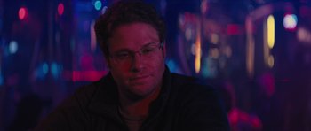 Movie still from “The Guilt Trip” (2012), directed by Anne Fletcher – A person wearing glasses with lights in the background; Close Up shot, Over the shoulder angle