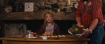 Movie still from “The Guilt Trip” (2012), directed by Anne Fletcher – A woman sitting at a table with a bowl of food; Medium shot, Over the shoulder angle