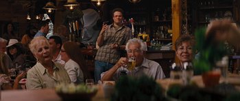Movie still from “The Guilt Trip” (2012), directed by Anne Fletcher – Two men sitting at a table drinking beer; Medium shot, Over the shoulder angle