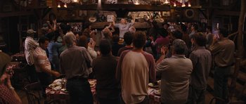 Movie still from “The Guilt Trip” (2012), directed by Anne Fletcher – A group of people standing in a room with hands in the air; Wide shot, Over the shoulder angle