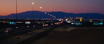 Movie still from “The Guilt Trip” (2012), directed by Anne Fletcher – A view of a highway at night with lights on; Extreme Wide shot, Low angle