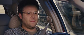 Movie still from “The Guilt Trip” (2012), directed by Anne Fletcher – A man sitting in the driver's seat of a car; Close Up shot, Over the shoulder angle