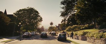 Movie still from “The Guilt Trip” (2012), directed by Anne Fletcher – Cars driving down a street lined with palm trees; Extreme Wide shot, High angle