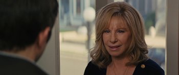 Movie still from “The Guilt Trip” (2012), directed by Anne Fletcher – A person wearing a black shirt near a window; Close Up shot, Over the shoulder angle