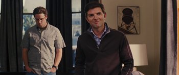 Movie still from “The Guilt Trip” (2012), directed by Anne Fletcher – A man standing in front of another man in front of a window; Medium shot, Over the shoulder angle