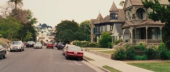 Movie still from “The Guilt Trip” (2012), directed by Anne Fletcher – Cars parked on the side of the road in front of a house; Extreme Wide shot, High angle