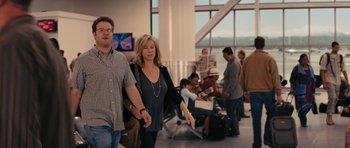 Movie still from “The Guilt Trip” (2012), directed by Anne Fletcher – A man and a woman walking through an airport terminal; Medium shot, Over the shoulder angle