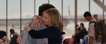 Movie still from “The Guilt Trip” (2012), directed by Anne Fletcher – A woman hugging a young man in front of a window; Medium shot, Over the shoulder angle