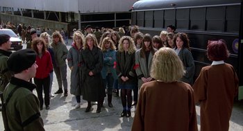 Movie still from “The Handmaid's Tale” (1990), directed by Volker Schlöndorff – A group of people standing in front of a bus; Wide shot, High angle
