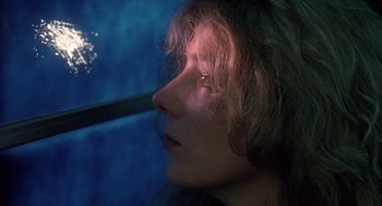 Movie still from “The Handmaid's Tale” (1990), directed by Volker Schlöndorff – A person looking out a window; Close Up shot, Low angle