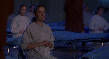 Movie still from “The Handmaid's Tale” (1990), directed by Volker Schlöndorff – A woman sitting on a floor in a room; Medium shot, High angle