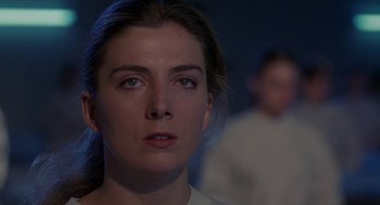 Movie still from “The Handmaid's Tale” (1990), directed by Volker Schlöndorff – A woman's face in the dark; Close Up shot, Over the shoulder angle