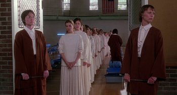 Movie still from “The Handmaid's Tale” (1990), directed by Volker Schlöndorff – A group of people standing next to each other in a room; Wide shot, High angle