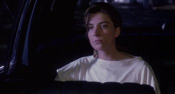 Movie still from “The Handmaid's Tale” (1990), directed by Volker Schlöndorff – A person sitting in a car looking out the window; Close Up shot, Low angle