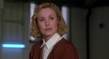 Movie still from “The Handmaid's Tale” (1990), directed by Volker Schlöndorff – A person wearing a suit and tie; Close Up shot, Over the shoulder angle