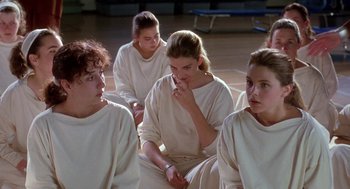 Movie still from “The Handmaid's Tale” (1990), directed by Volker Schlöndorff – A group of young people sitting in a circle; Medium shot, High angle