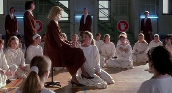 Movie still from “The Handmaid's Tale” (1990), directed by Volker Schlöndorff – A group of people sitting on the floor in a room; Wide shot, High angle