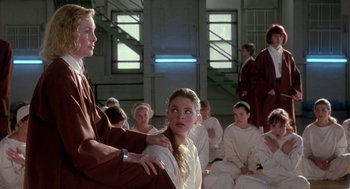 Movie still from “The Handmaid's Tale” (1990), directed by Volker Schlöndorff – A group of young people sitting in a room; Medium shot, Over the shoulder angle