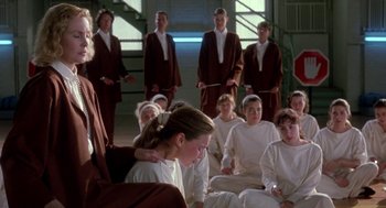 Movie still from “The Handmaid's Tale” (1990), directed by Volker Schlöndorff – A group of young people sitting in front of each other; Medium shot, Over the shoulder angle