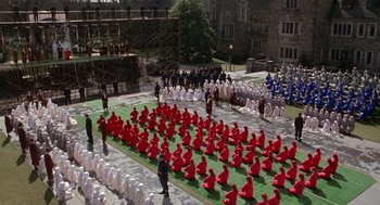 Movie still from “The Handmaid's Tale” (1990), directed by Volker Schlöndorff – A group of people dressed in red sitting on the grass; Extreme Wide shot, High angle