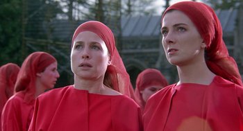 Movie still from “The Handmaid's Tale” (1990), directed by Volker Schlöndorff – A group of women in red dresses and red headscarves; Close Up shot, Low angle
