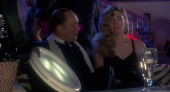 Movie still from “The Handmaid's Tale” (1990), directed by Volker Schlöndorff – A man and a woman sitting next to each other; Medium shot, Over the shoulder angle