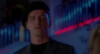 Movie still from “The Handmaid's Tale” (1990), directed by Volker Schlöndorff – A person wearing a suit and a hat; Close Up shot, Low angle