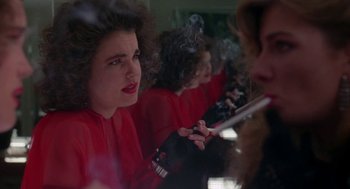 Movie still from “The Handmaid's Tale” (1990), directed by Volker Schlöndorff – A group of people sitting in a room smoking cigarettes; Close Up shot, Over the shoulder angle