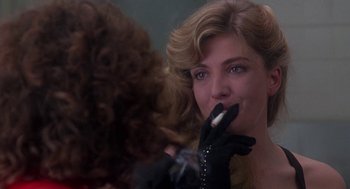 Movie still from “The Handmaid's Tale” (1990), directed by Volker Schlöndorff – A woman putting lipstick on another woman in a mirror; Close Up shot, Over the shoulder angle