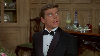 Movie still from “The Happiest Millionaire” (1967), directed by Norman Tokar – A man in a tuxedo looking surprised at something; Close Up shot, Low angle