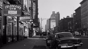 Movie still from “The Harder They Fall” (1956), directed by Mark Robson – An old black and white photo of a city street; Extreme Wide shot, High angle